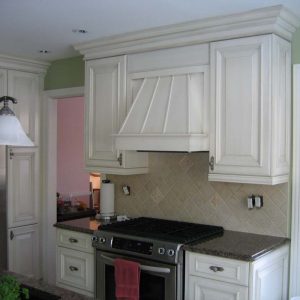 white kitchen range hood and cabinets